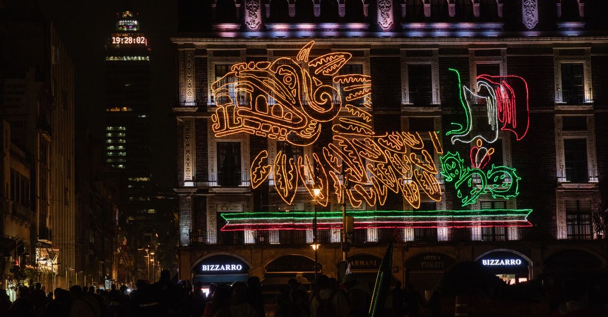 Illuminated building in Mexico City during Independence Day celebration at night.