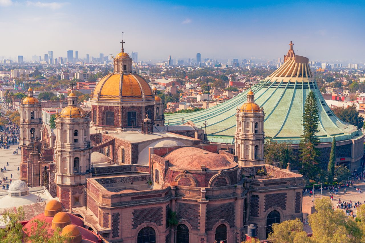 Aerial view of the historic Basílica de Santa María de Guadalupe and the cityscape of Mexico City.