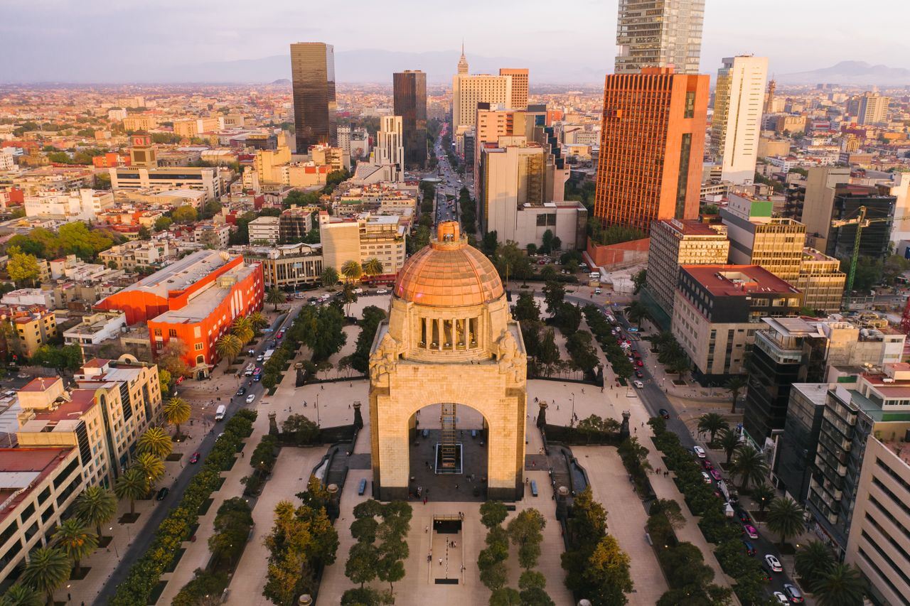 Stunning aerial view of Mexico City's Monumento a la Revolución surrounded by cityscape.